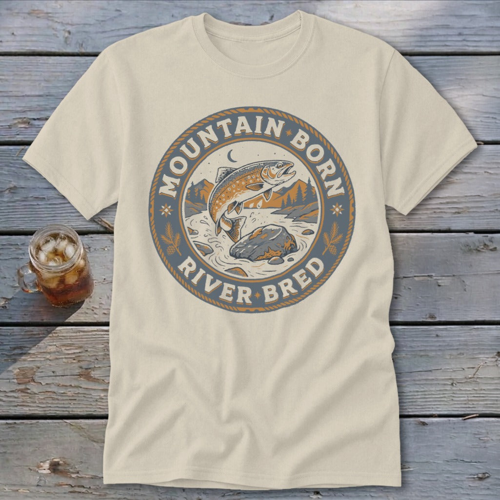 Light beige t-shirt with circular graphic of jumping trout and text "Mountain Born River Bred".