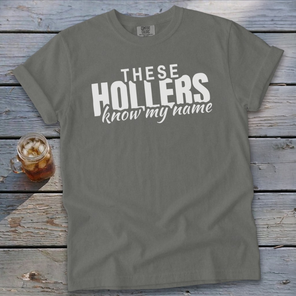 Gray t-shirt with white text "THESE HOLLERS know my name"