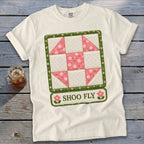 White t-shirt with a "Shoo Fly" quilt block graphic and floral accents.