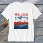 A white V-neck t-shirt featuring the text "STARS, STRIPES & SWEET TEA" above a red, white, and blue mountain graphic.