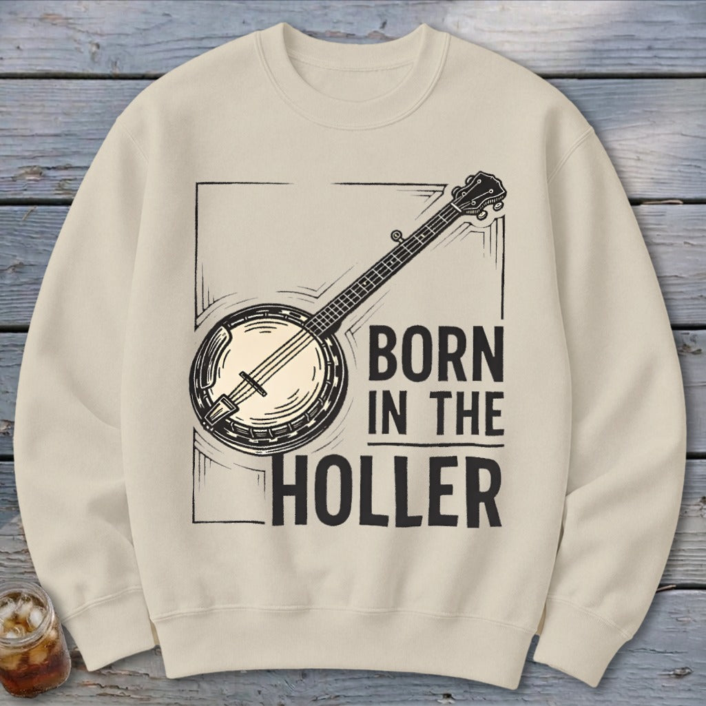 Cream sweatshirt with banjo graphic and text "BORN IN THE HOLLER".