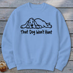 Light blue crewneck sweatshirt featuring a black graphic of a sleeping hound dog and the text That Dog Won't Hunt.