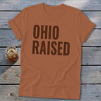 Brown "Ohio Raised" text on a brown t-shirt next to a mason jar drink.