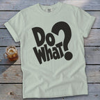 Light sage green t-shirt with rolled sleeves featuring bold black text reading Do What? on wooden surface.
