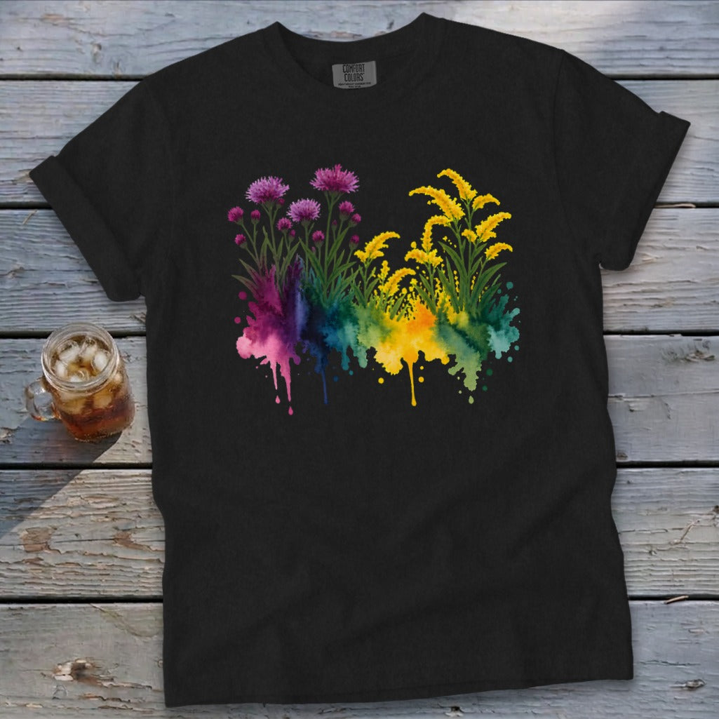 Black t-shirt with watercolor floral design featuring pink and yellow flowers and paint splatters.
