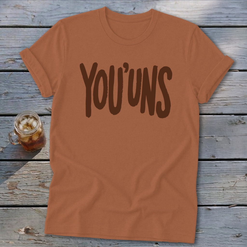 Orange t-shirt with "YOU'UNS" printed in brown text.