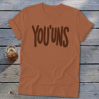 Orange t-shirt with "YOU'UNS" printed in brown text.