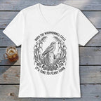 A white V-neck t-shirt with a black line art graphic of a bird on a fence post surrounded by corn stalks and the text "When the whippoorwill calls, it's time to plant corn."