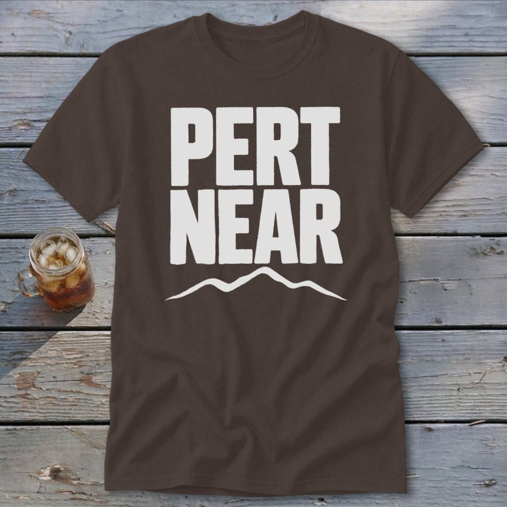A dark brown t-shirt featuring the white text PERT NEAR and a mountain range graphic underneath.