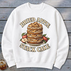 White sweatshirt with a "Dried Apple Stack Cake" graphic featuring a layered cake and apples.