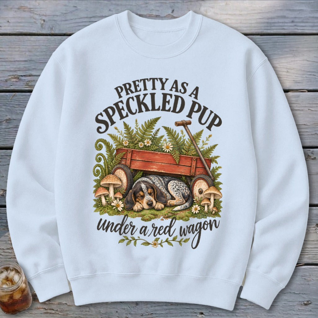Speckled pup sleeping under a red wagon with mushrooms and ferns, "Pretty As A Speckled Pup" text.