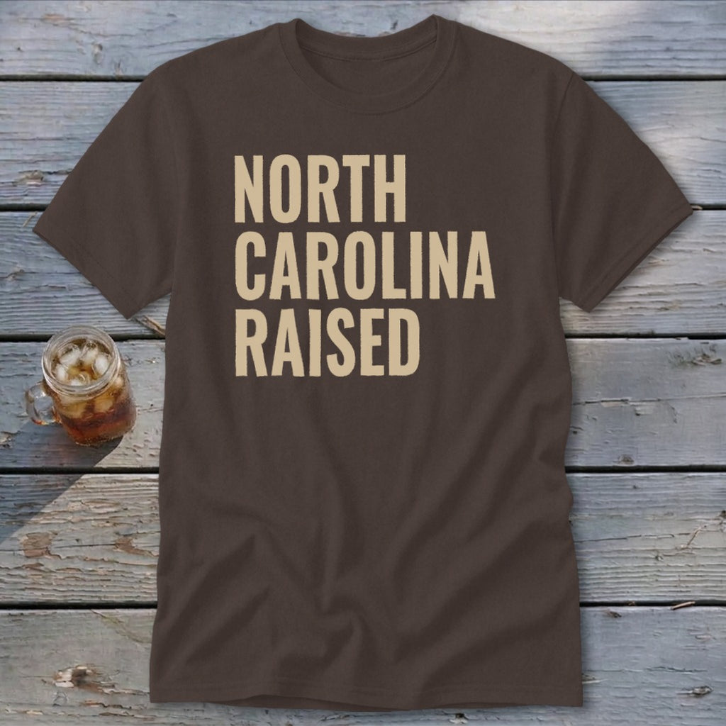 Brown t-shirt with "NORTH CAROLINA RAISED" text in beige.