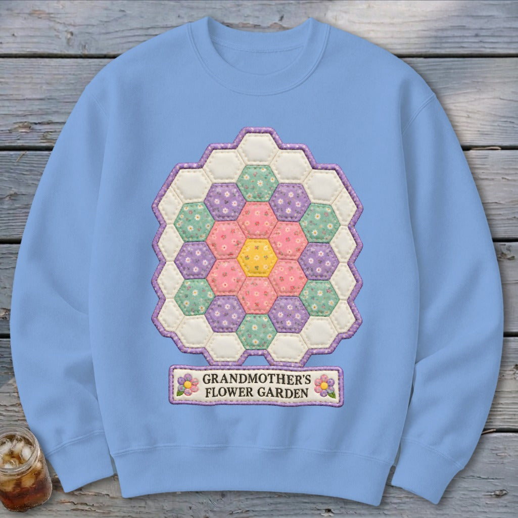 Light blue sweatshirt with hexagon patchwork design and "Grandmother's Flower Garden" text.