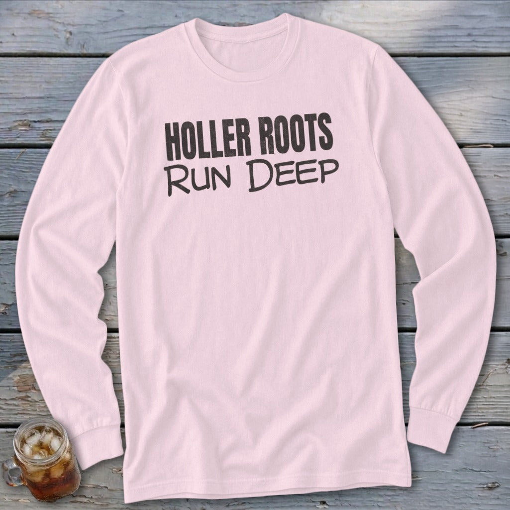 Pink long-sleeved shirt with black text that reads "HOLLER ROOTS RUN DEEP".