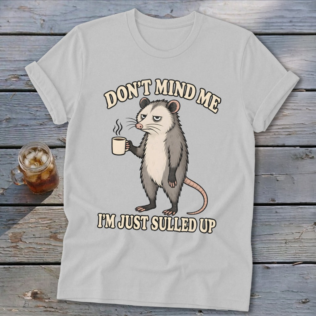 Gray t-shirt with opossum holding coffee mug, text reads "Don't mind me, I'm just sulled up."