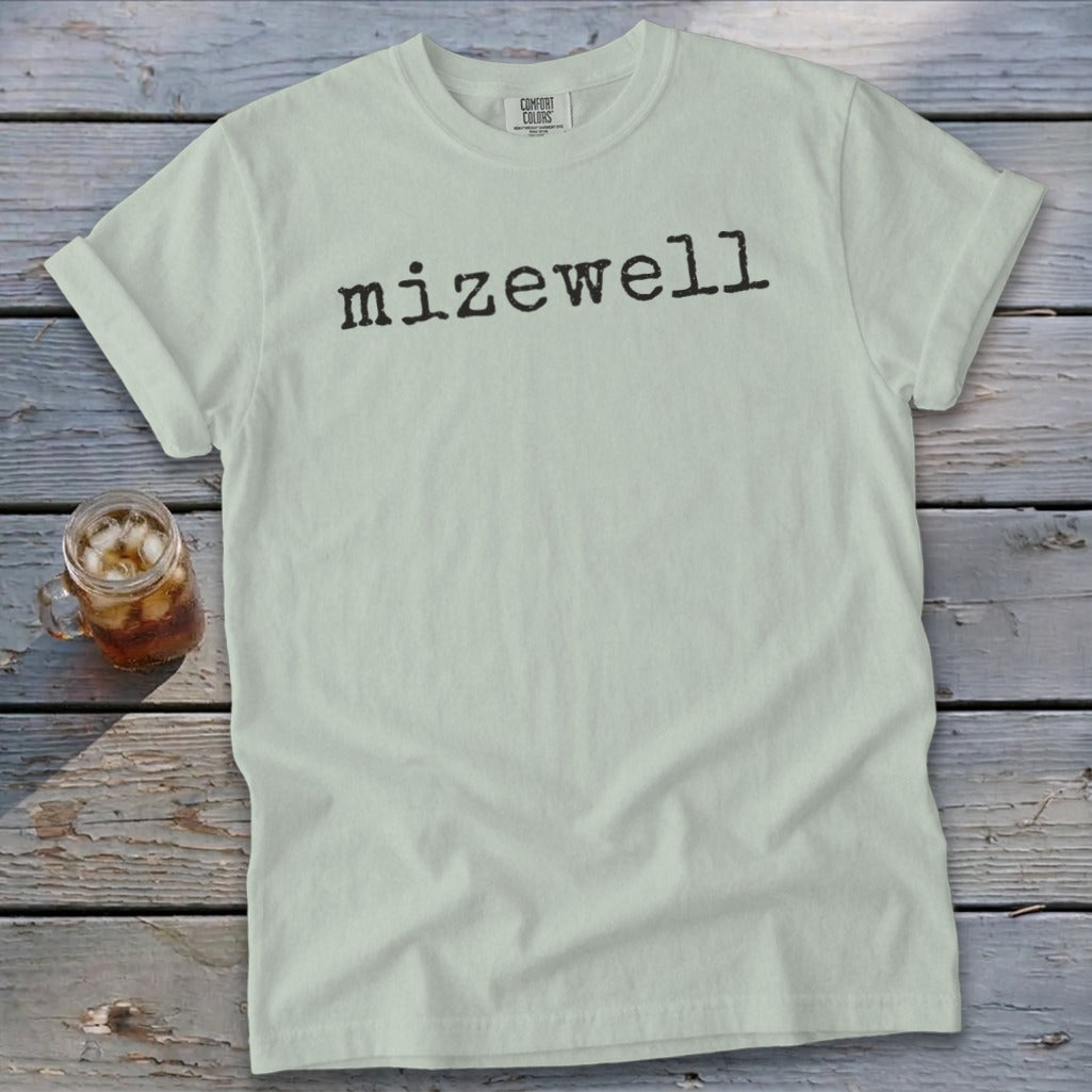 Light mint t-shirt with "mizewell" in black typewriter font.