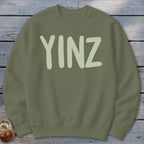 Olive green sweatshirt with "YINZ" printed in light green on the front.