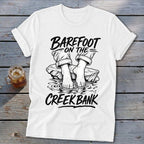 White t-shirt graphic with "Barefoot On The Creek Bank" text and bare feet in water.