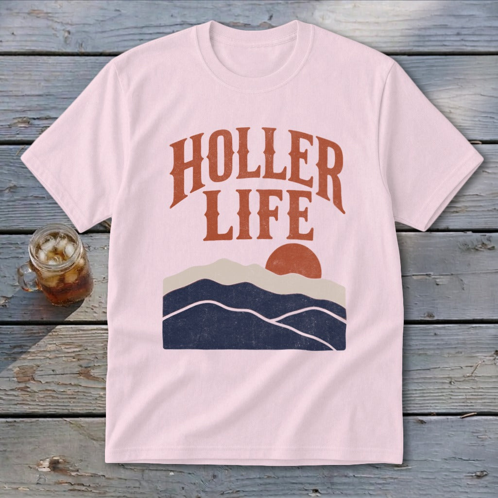 Light pink short-sleeved t-shirt with orange text reading HOLLER LIFE above a stylized mountain sunset graphic.