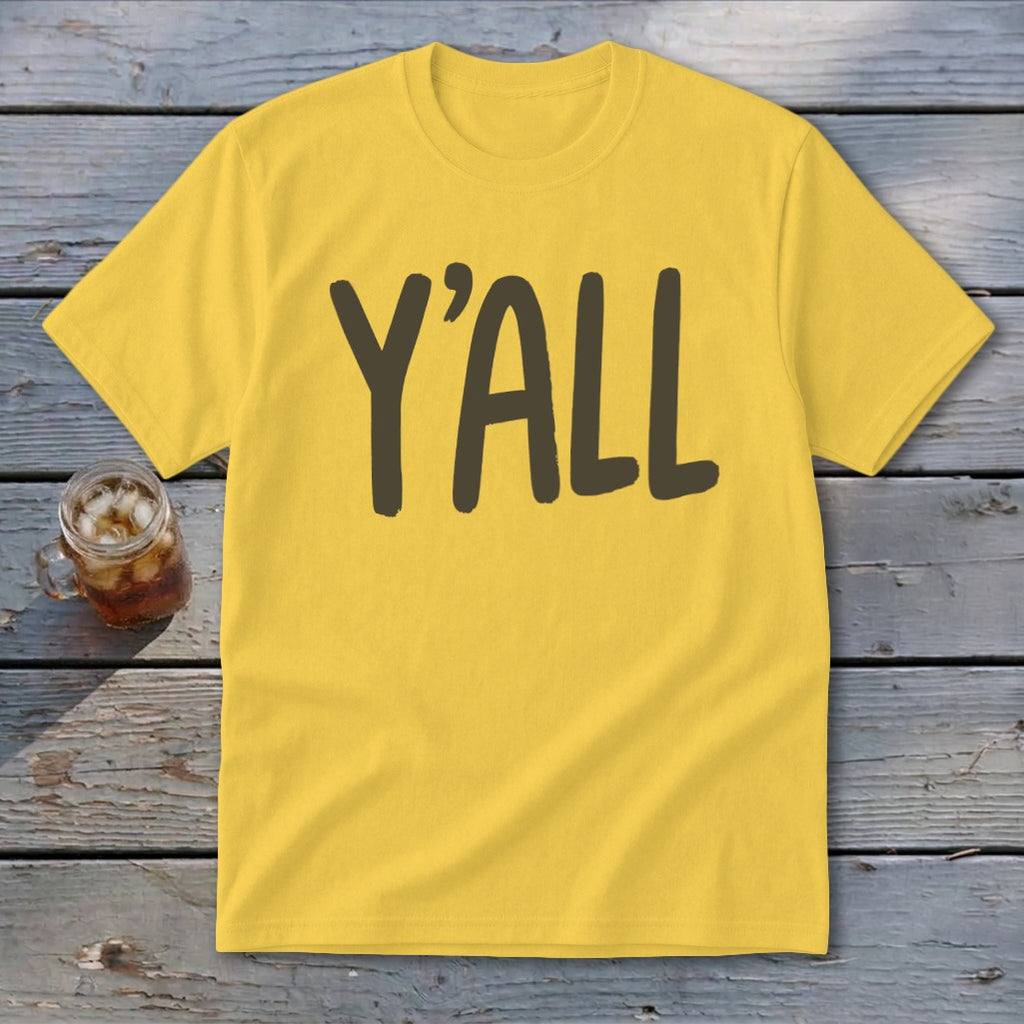 Yellow t-shirt with dark brown text reading "Y'ALL" next to a glass of iced tea.