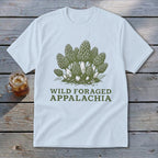 White t-shirt with a green graphic of morel mushrooms and text "WILD FORAGED APPALACHIA".