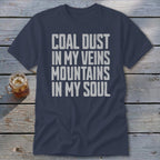 Dark blue t-shirt featuring the distressed white text COAL DUST IN MY VEINS MOUNTAINS IN MY SOUL.