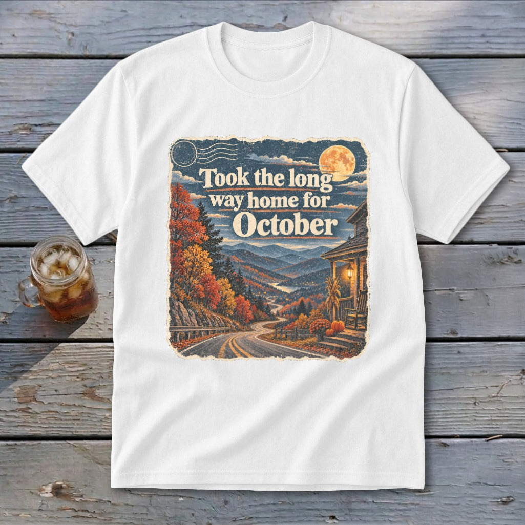 White t-shirt graphic with "Took the long way home for October" text and autumn mountain scene.
