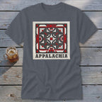 Dark gray t-shirt featuring a geometric quilt design and the word Appalachia on a wooden background.