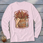 Pink long-sleeve shirt with a "Sorghum" graphic of stalks in a wooden barrel.