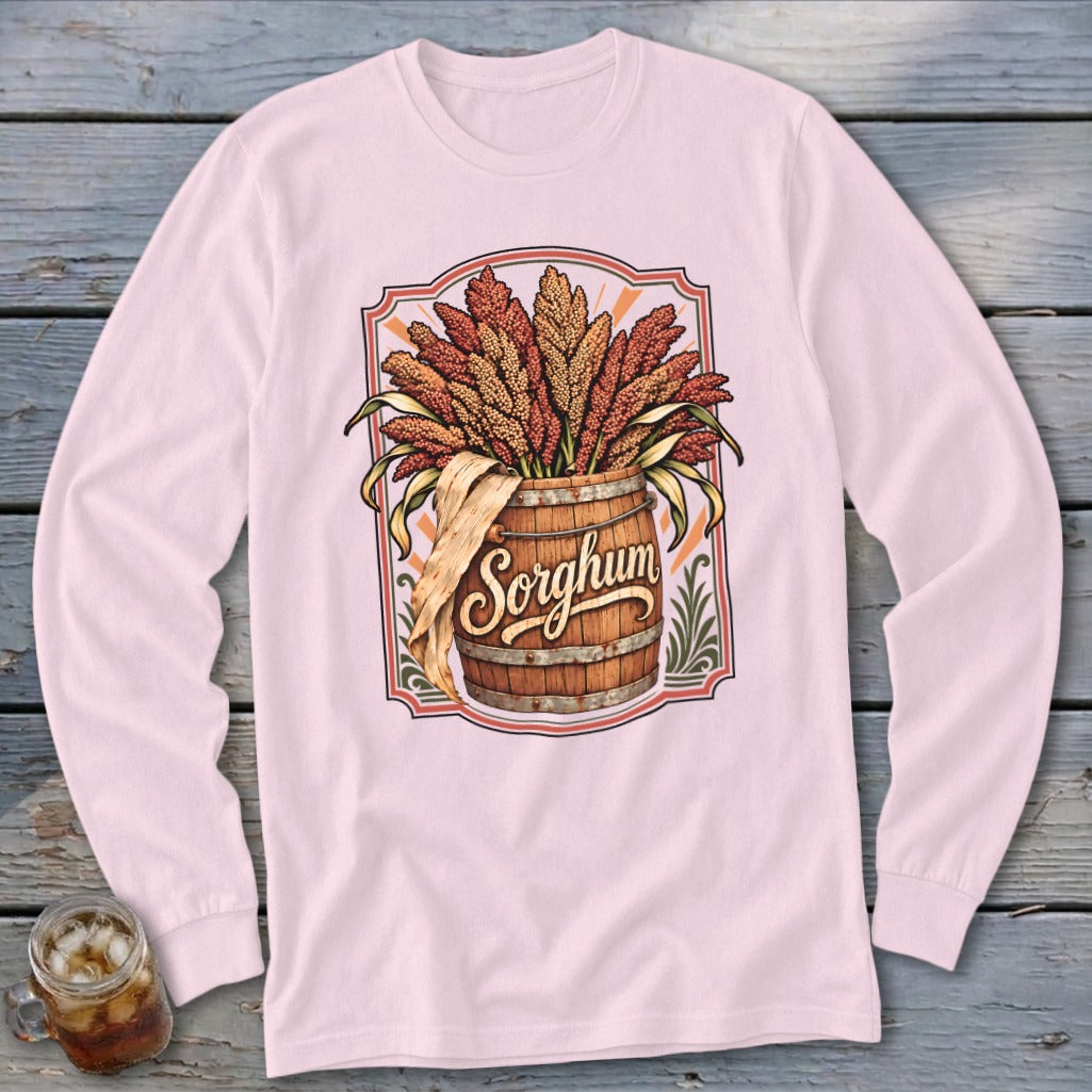 Pink long-sleeve shirt with a "Sorghum" graphic of stalks in a wooden barrel.