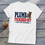 White t-shirt with "PLUMB TUCKERED OUT AND IT AIN'T EVEN DINNER" text and rocking chair graphic.