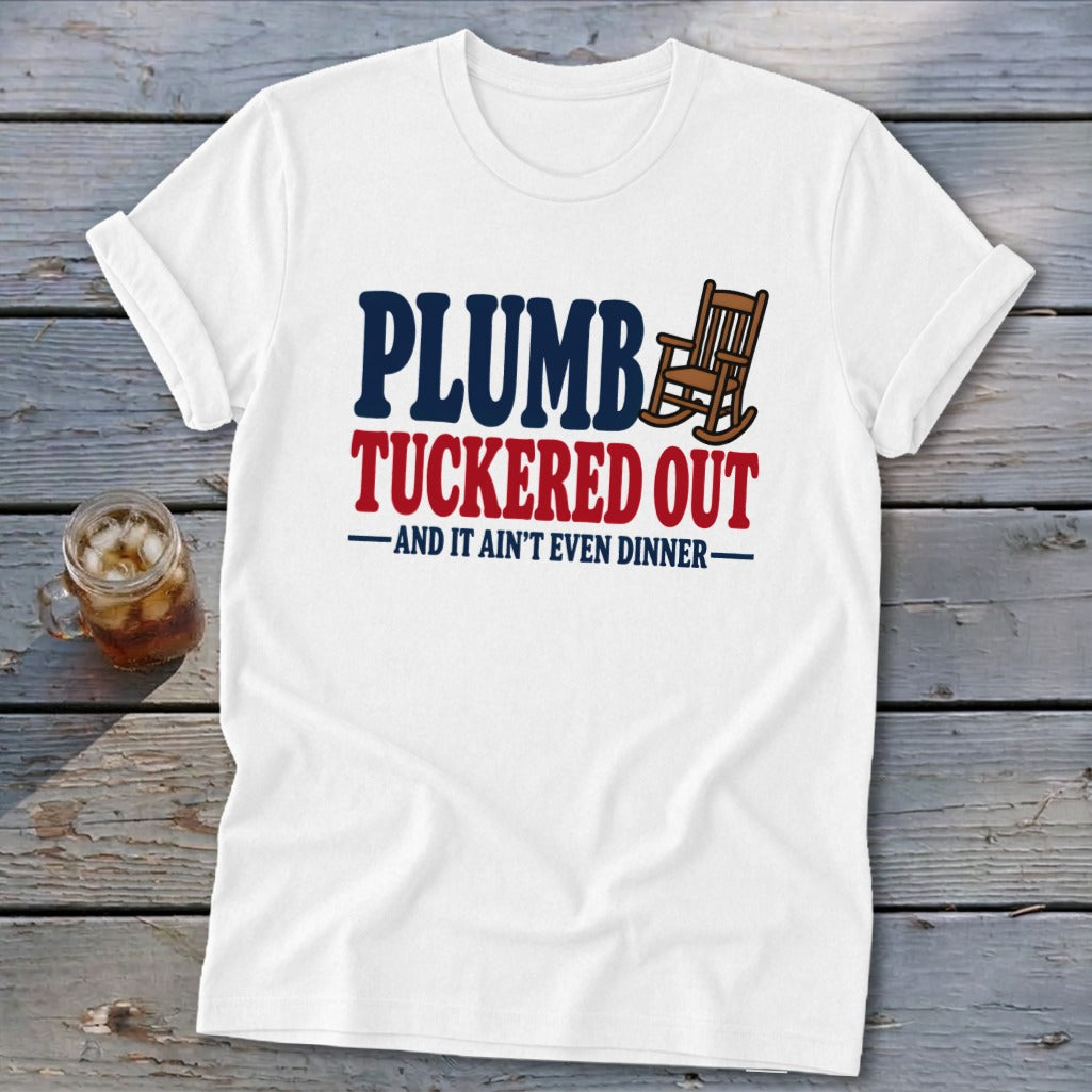 White t-shirt with "PLUMB TUCKERED OUT AND IT AIN'T EVEN DINNER" text and rocking chair graphic.