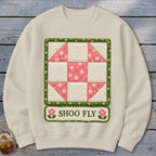 Cream sweatshirt with a quilt block design and the text "SHOO FLY".