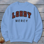 Light blue crewneck sweatshirt with "LORDY MERCY" text in distressed red and black lettering.