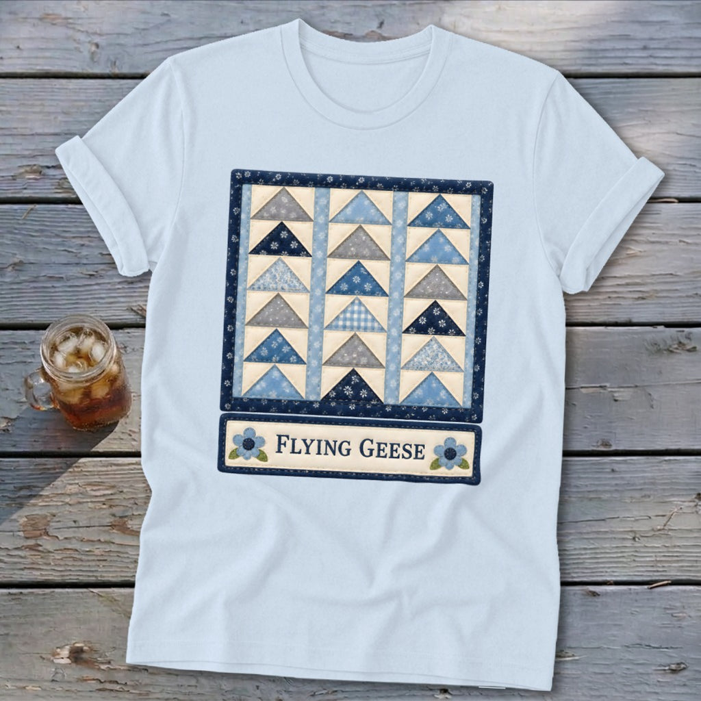 Light blue t-shirt with a framed "Flying Geese" quilt block design.