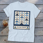 Light blue t-shirt with a framed "Flying Geese" quilt block design.