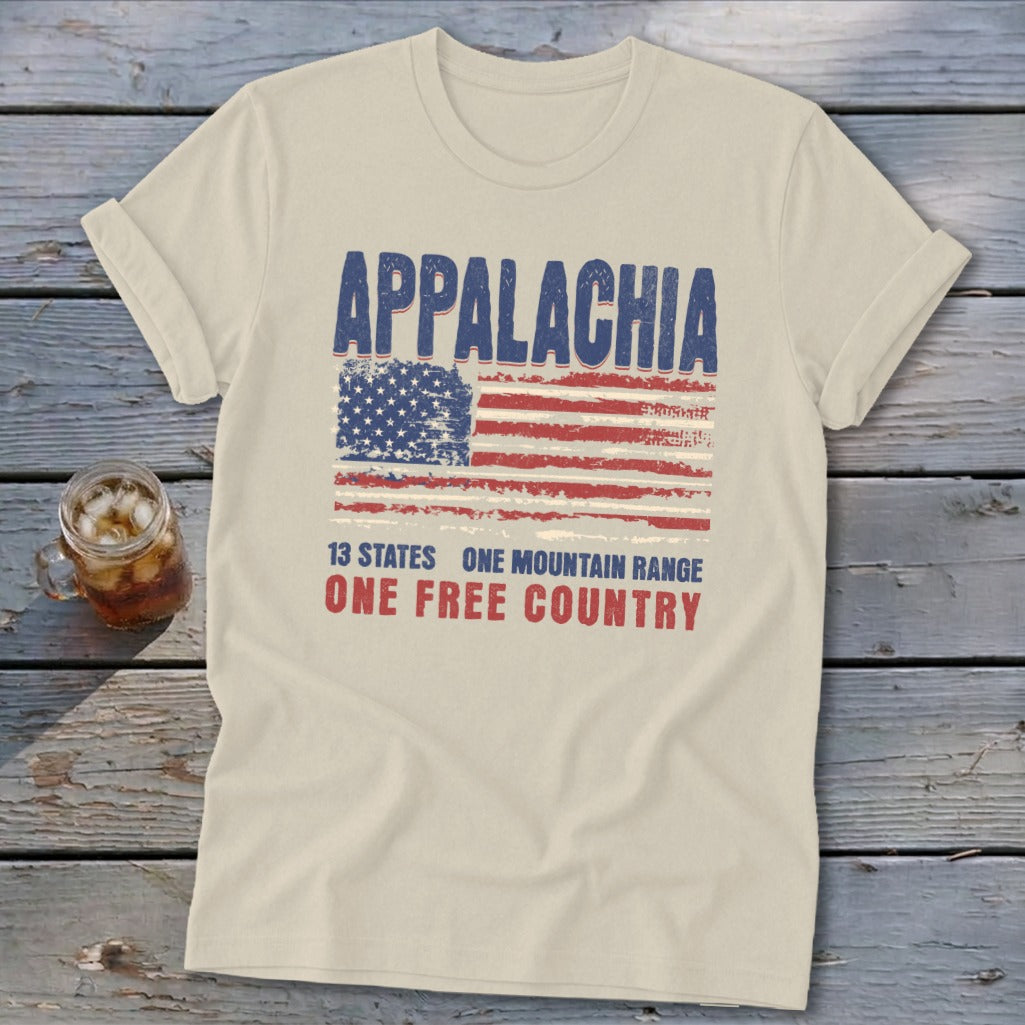 Cream-colored t-shirt featuring a distressed American flag graphic with the text Appalachia, 13 states, and one free country.