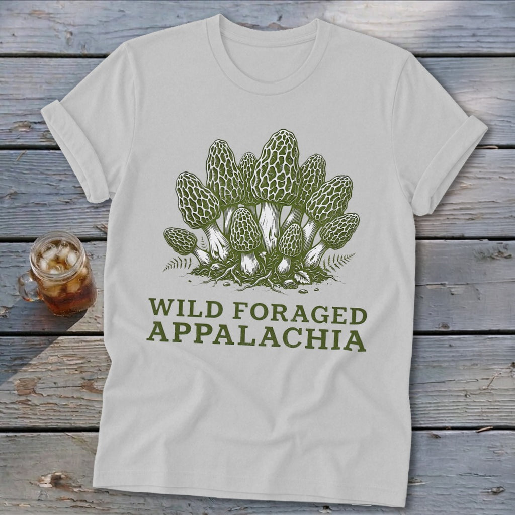 White t-shirt with green illustration of morel mushrooms and text "WILD FORAGED APPALACHIA".