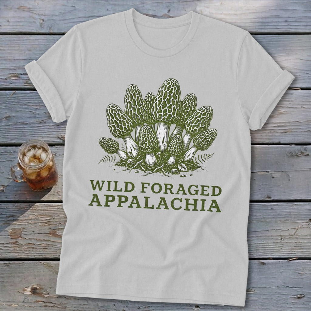 White t-shirt with green illustration of morel mushrooms and text "WILD FORAGED APPALACHIA".
