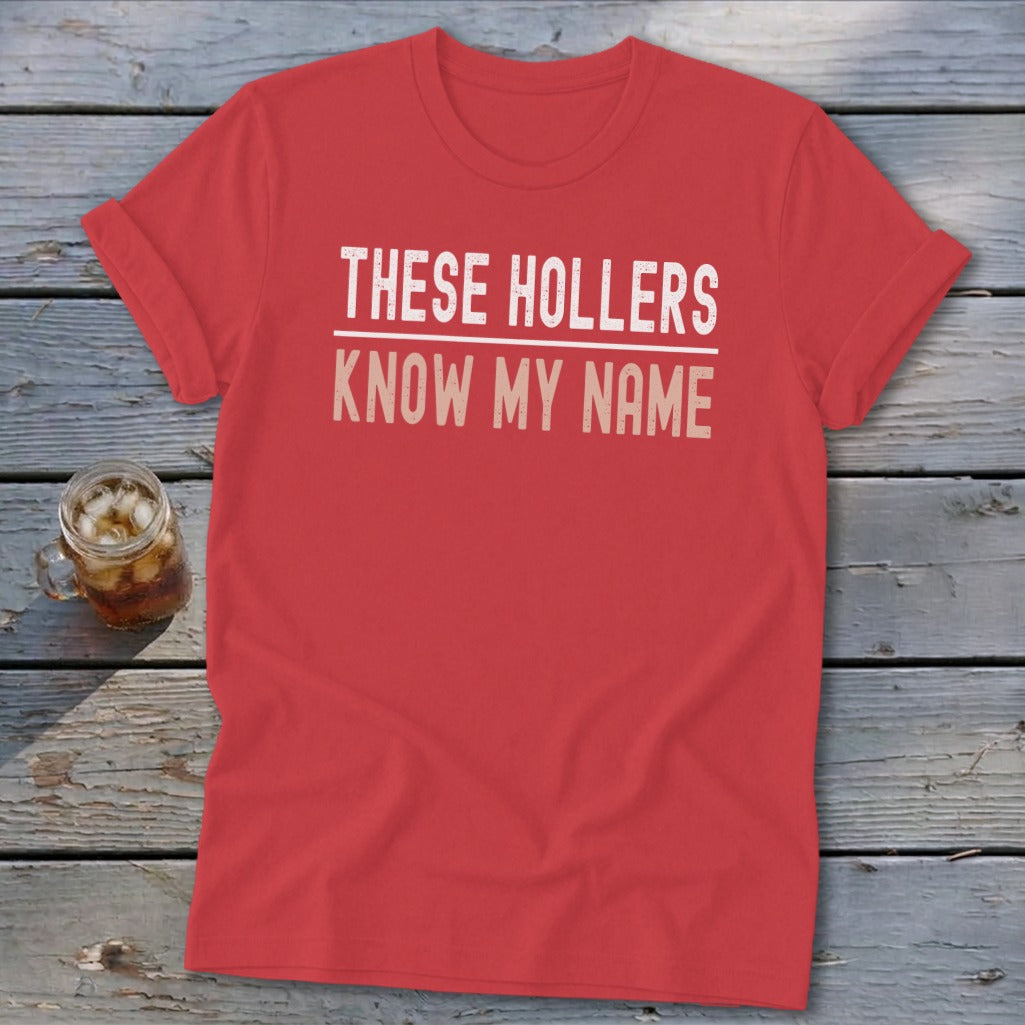 Red t-shirt with text "THESE HOLLERS KNOW MY NAME".