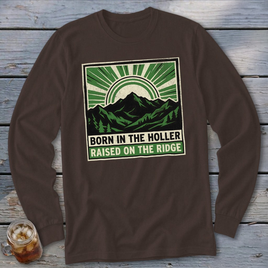 Brown long-sleeve t-shirt with a green and white mountain graphic featuring text that reads BORN IN THE HOLLER RAISED ON THE RIDGE.