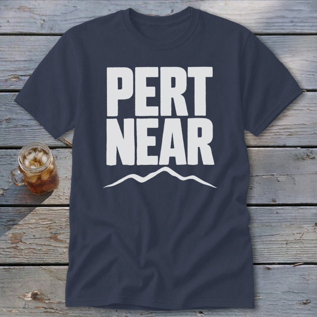 A dark blue crewneck t-shirt featuring the white text PERT NEAR above a mountain range graphic.