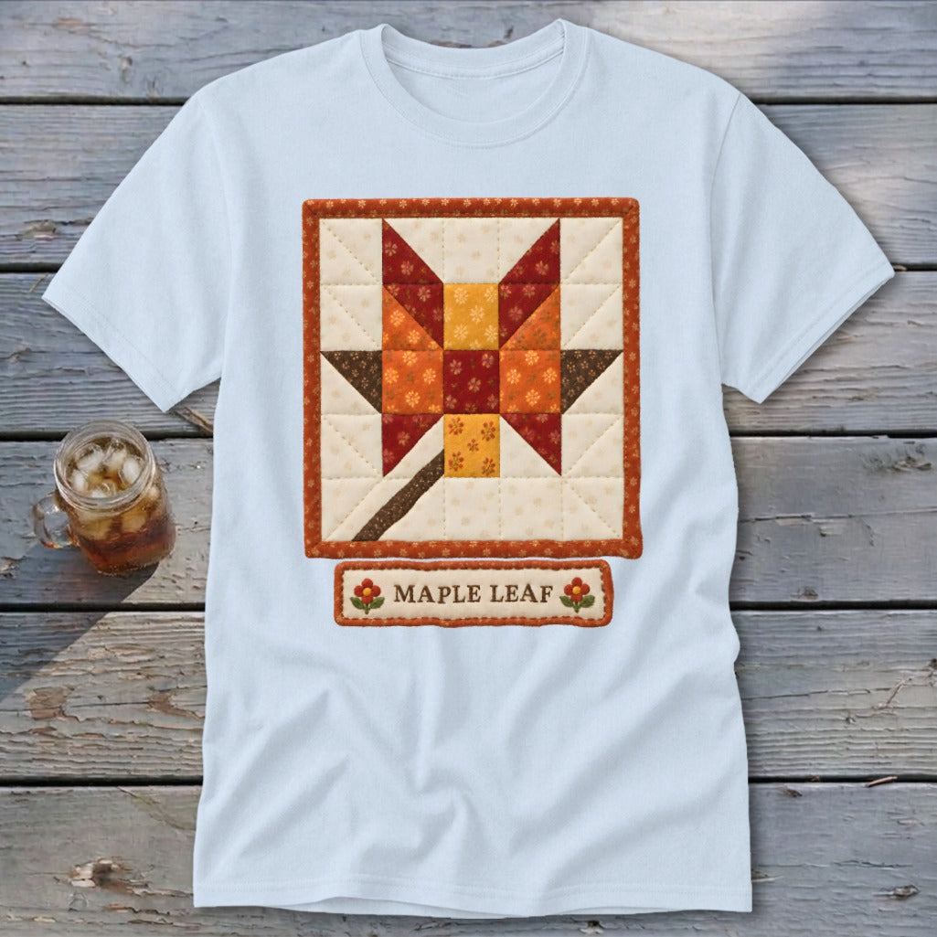 Light blue t-shirt with a quilt block featuring a maple leaf design and the text "MAPLE LEAF".