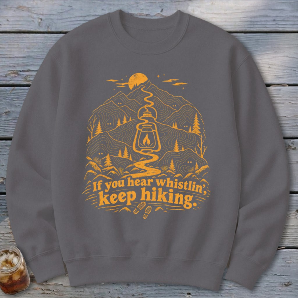 Grey sweatshirt with orange hiking graphic and text "If you hear whistlin', keep hiking."