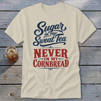 Beige t-shirt featuring blue and red text reading Sugar in my sweat tea never in my cornbread.