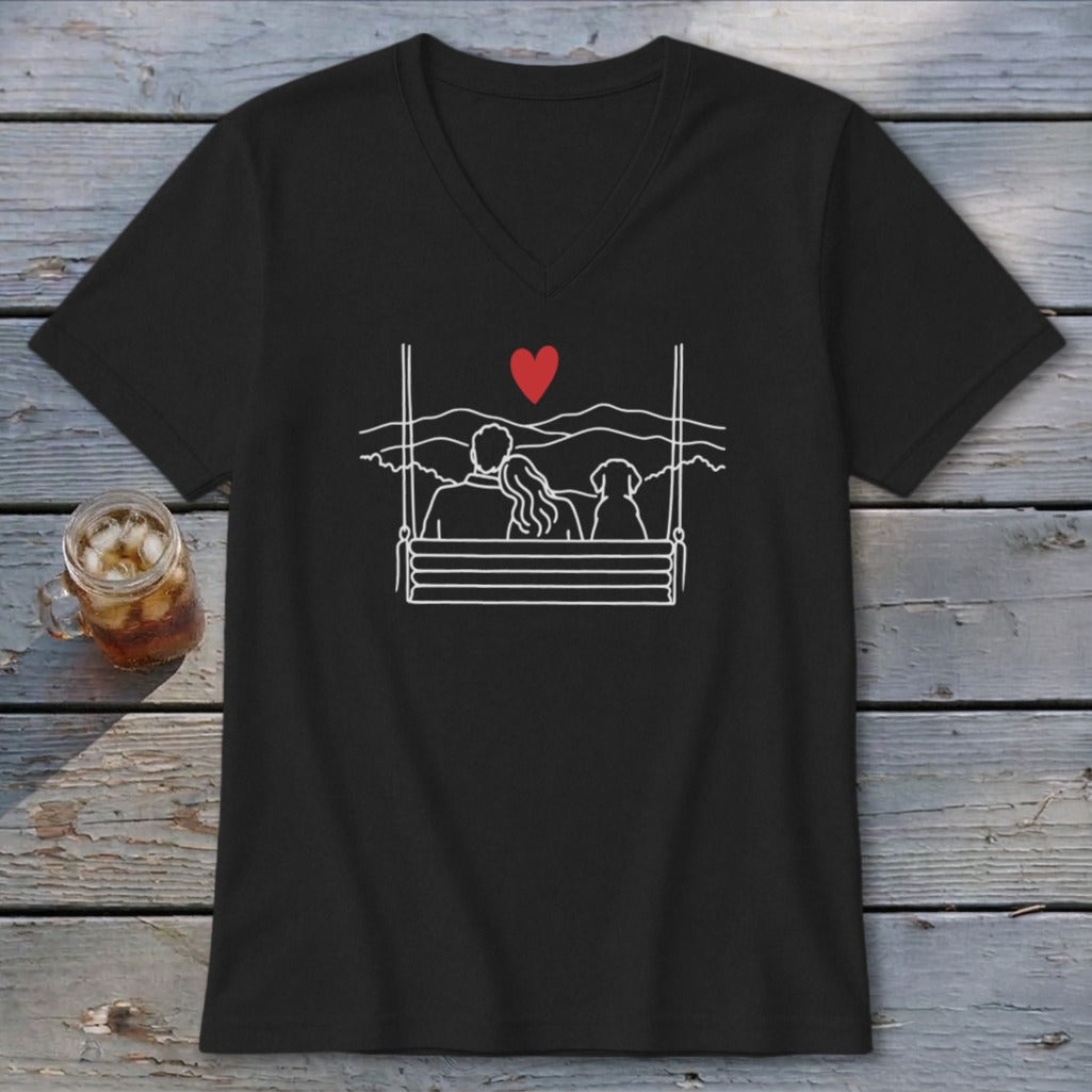 Black v-neck shirt with line art of a couple and dog on a swing, with a red heart.