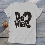 Light gray t-shirt with rolled sleeves featuring the black text Do What? on a wooden background.