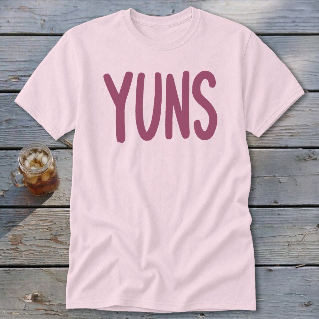 Pink t-shirt with large purple "YUNS" text and a glass of iced tea.