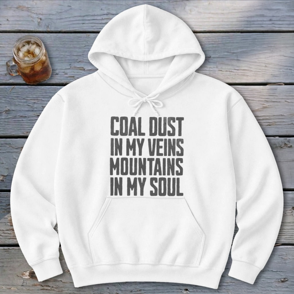 A white hooded sweatshirt featuring the black distressed text Coal Dust in My Veins Mountains in My Soul.