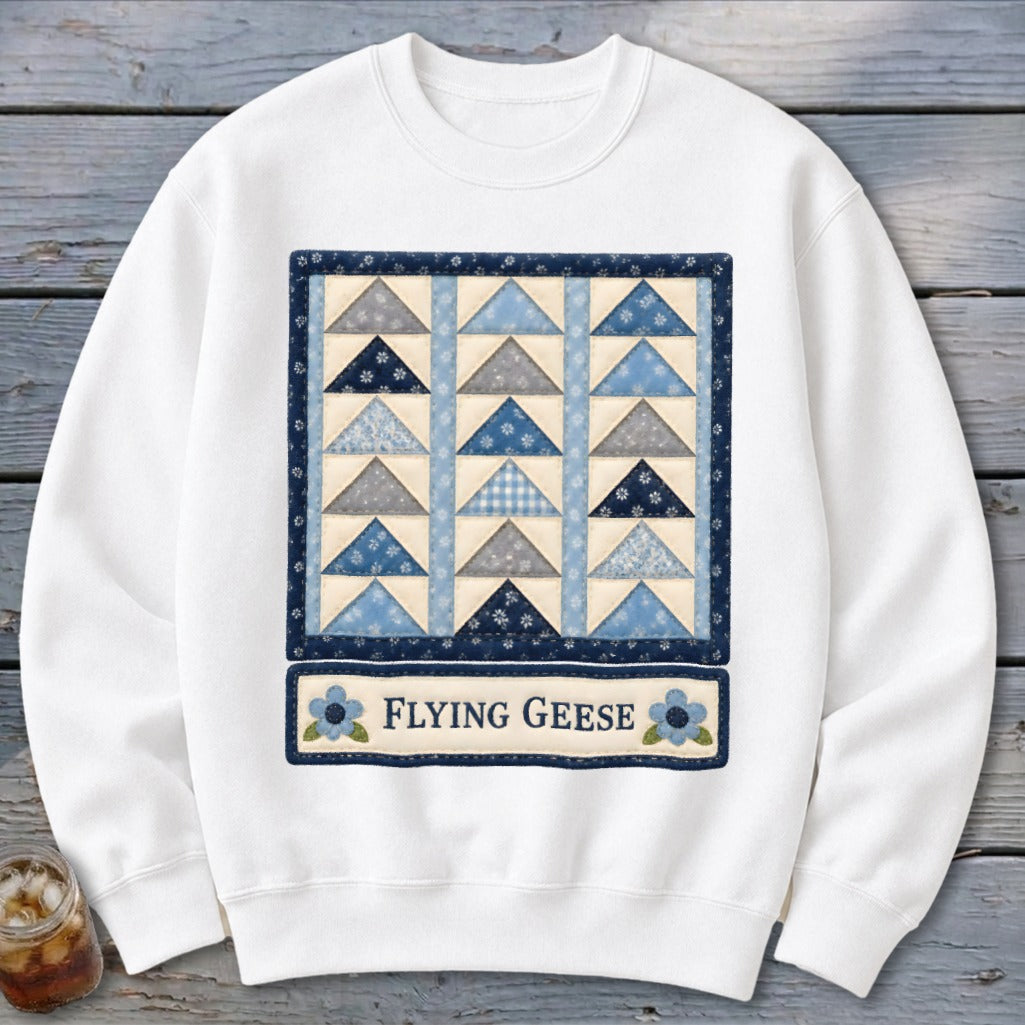 White sweatshirt with a "Flying Geese" quilt pattern and text.